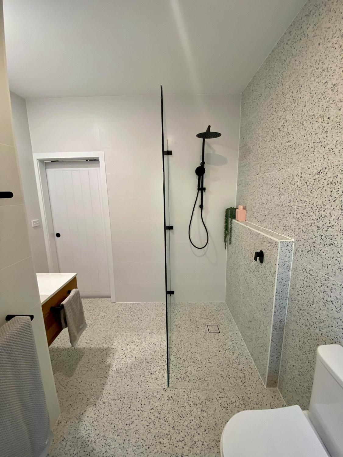 A Bathroom with A Walk in Shower, Toilet and Sink — Entire Trades in Maitland, NSW