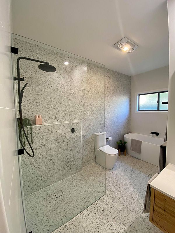 Interior Of A Bathroom Featuring A Shower, Toilet, And Sink — Entire Trades in Cessnock, NSW