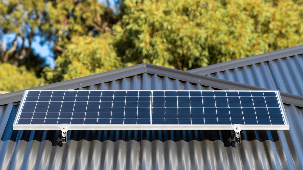 Solar Panels Mounted On A Corrugated Metal Roof — Entire Trades in Maitland, NSW