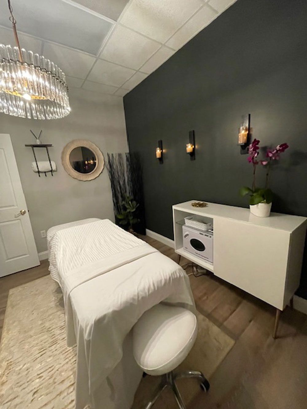 There is a massage table in the middle of the room.