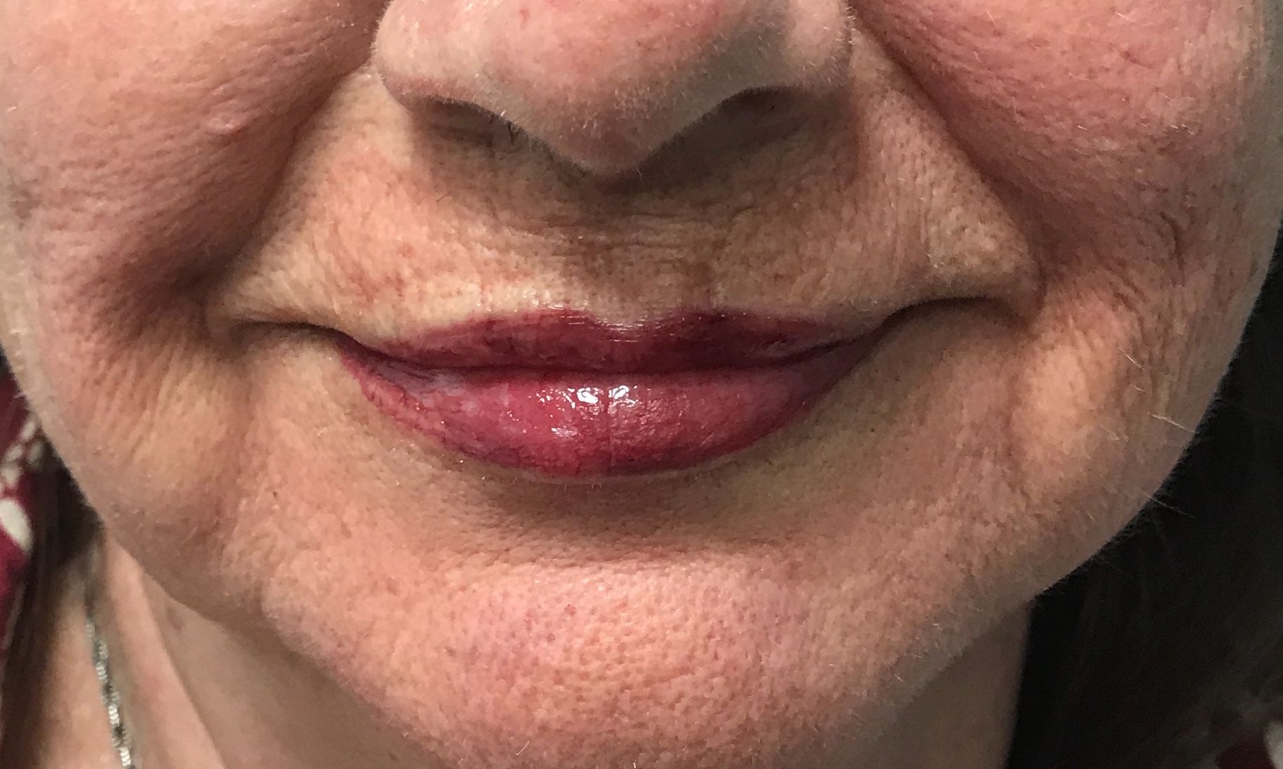 A close up of a woman 's lips with red lipstick.