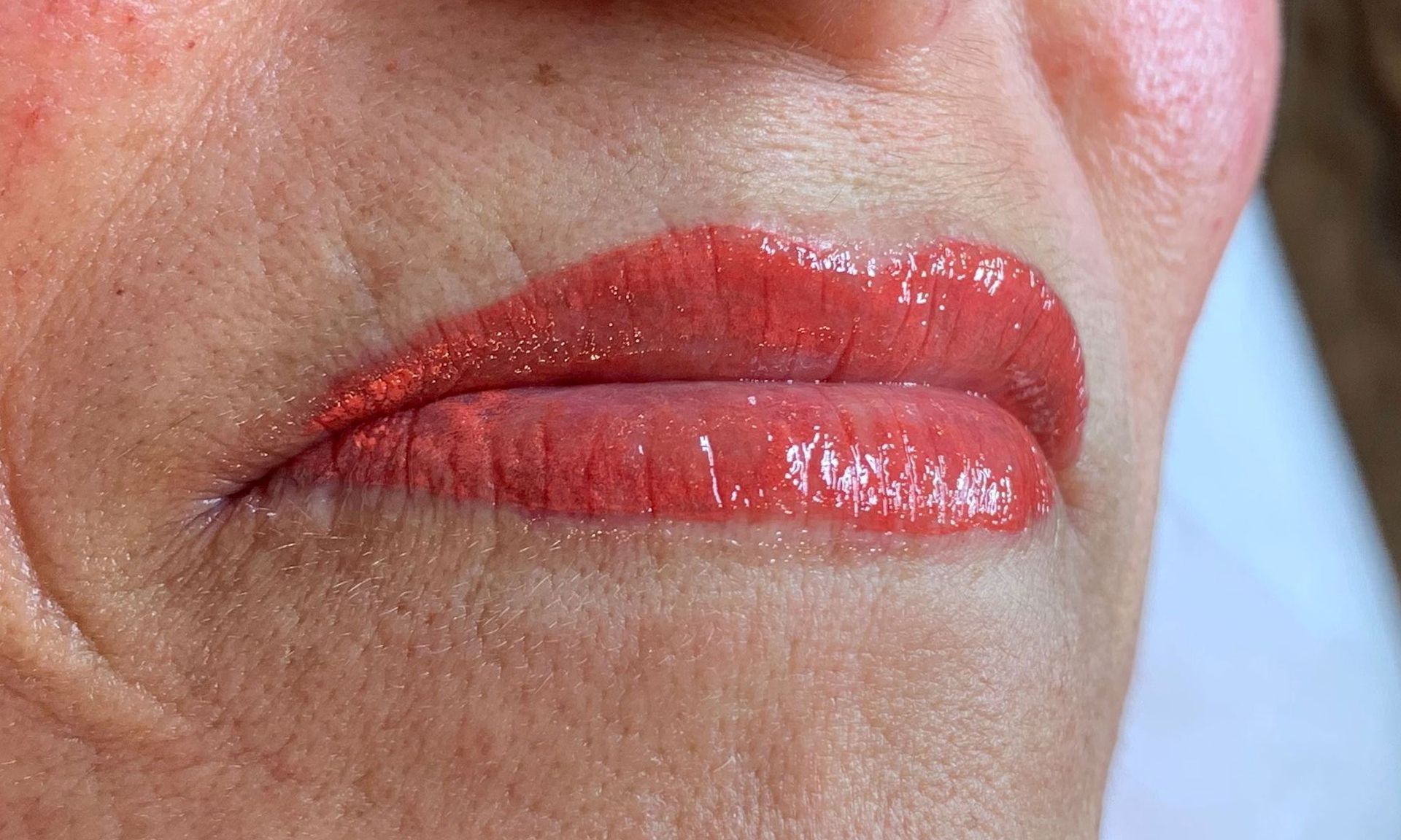 A close up of a woman 's lips with red lipstick.