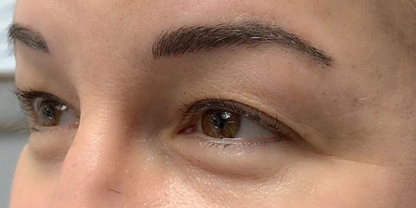 A close up of a woman 's eyes and eyebrows.