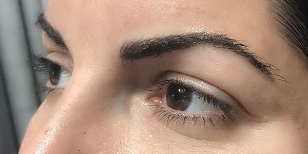 A close up of a woman 's eye and eyebrows.