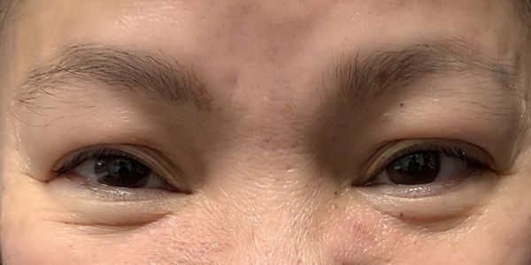 A close up of a woman 's eyes and forehead.