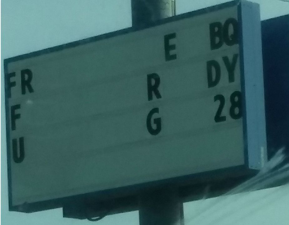 Old sign with random letters spaced out that indicates business has gone out of business.