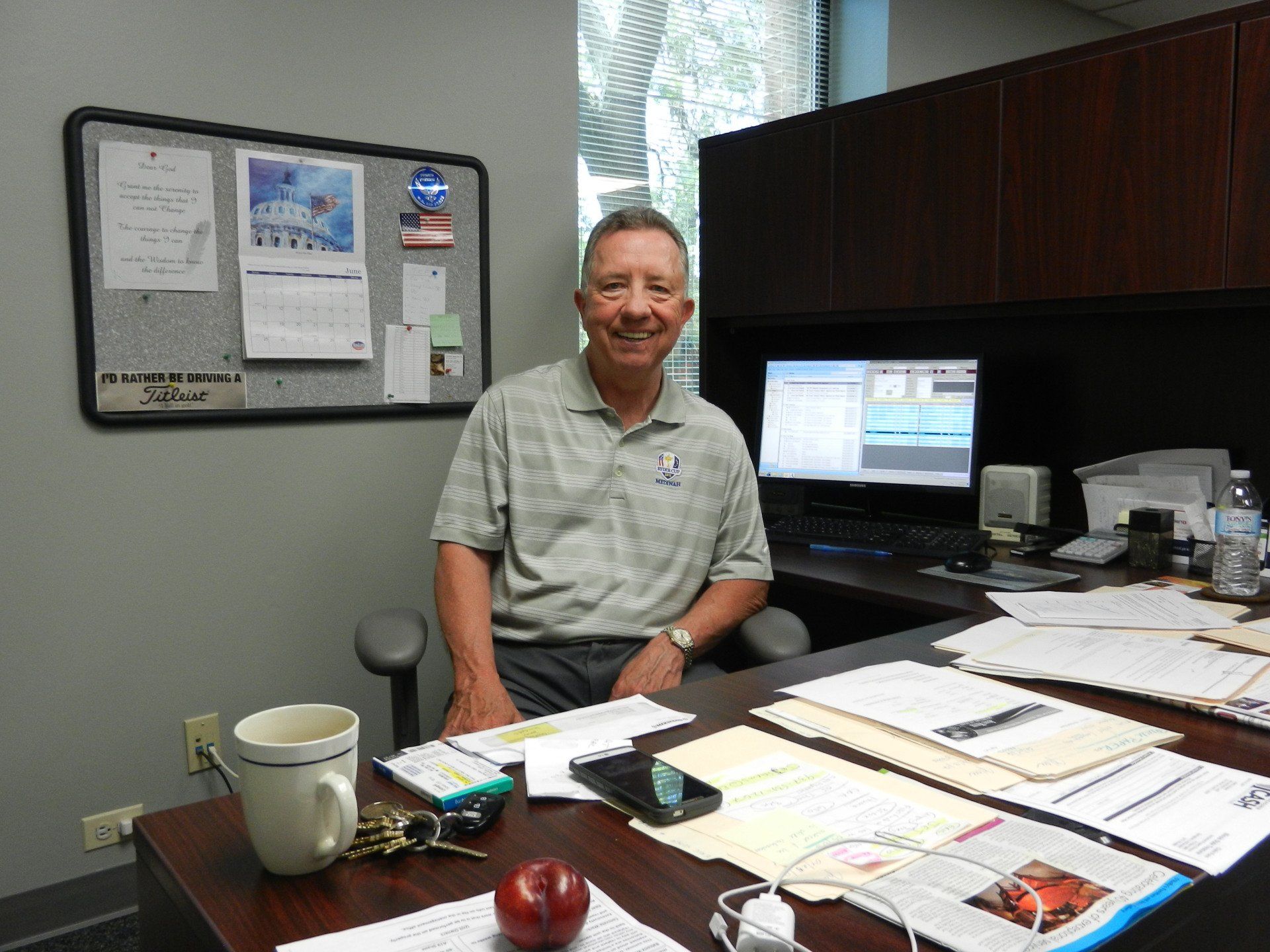 A man is sitting at a desk in front of a computer.