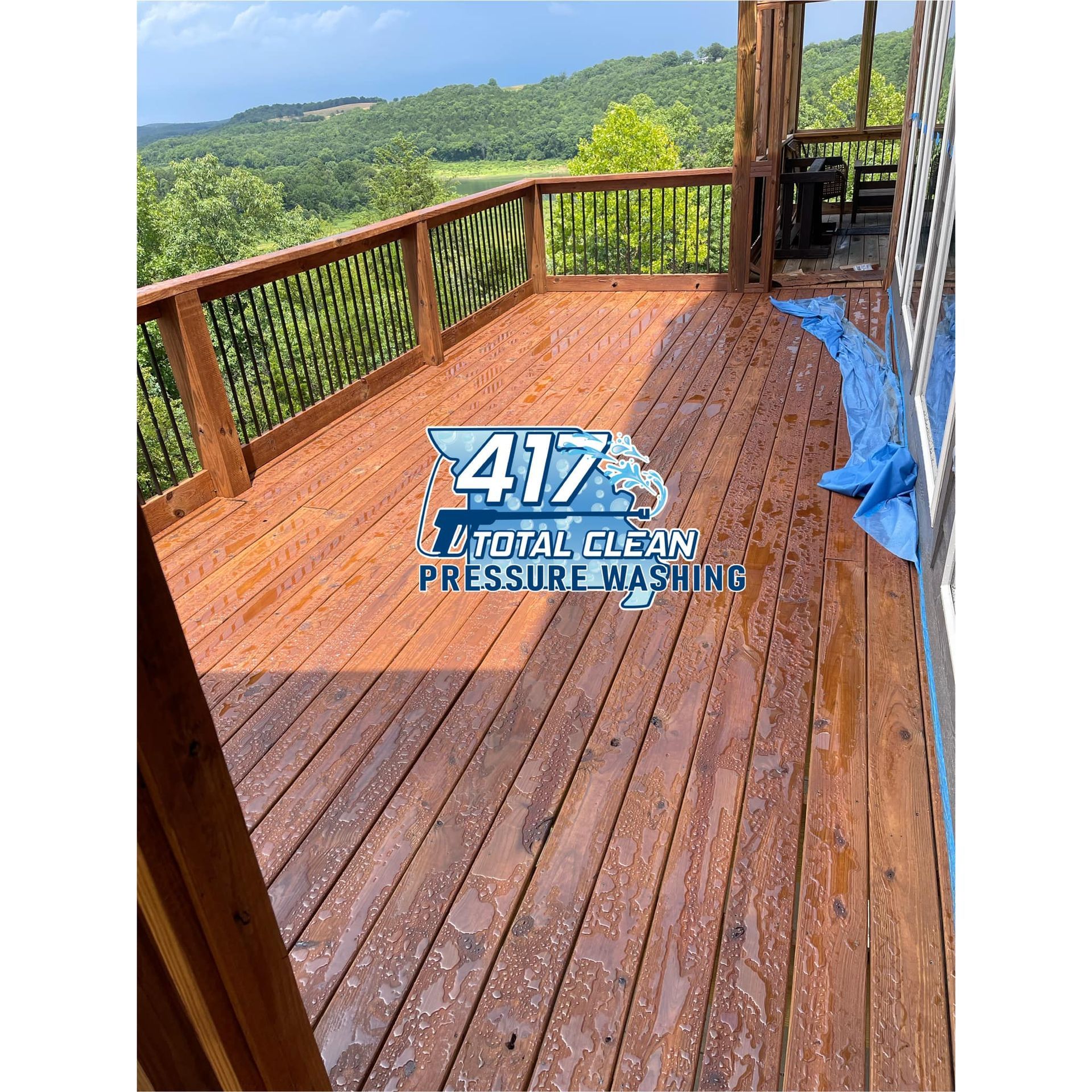A wooden deck with a view of the ocean and mountains.