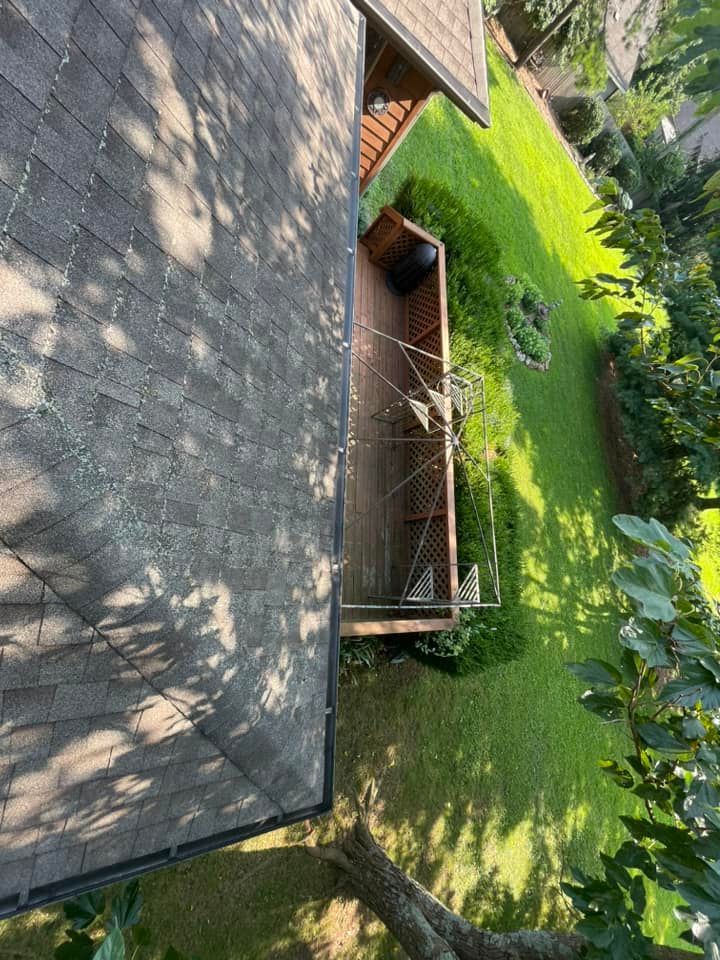 An aerial view of a house with a roof and a deck.