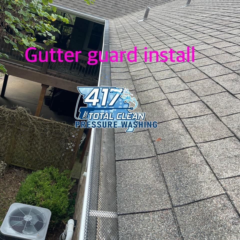 A gutter guard is being installed on the roof of a house.