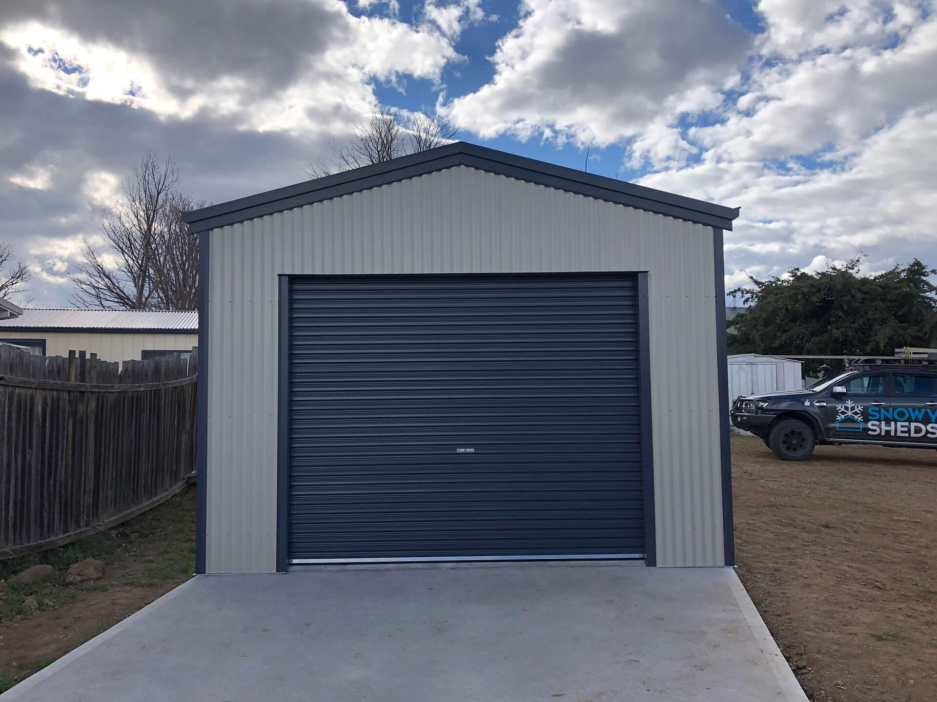 white shed with blue door - Snowy Sheds