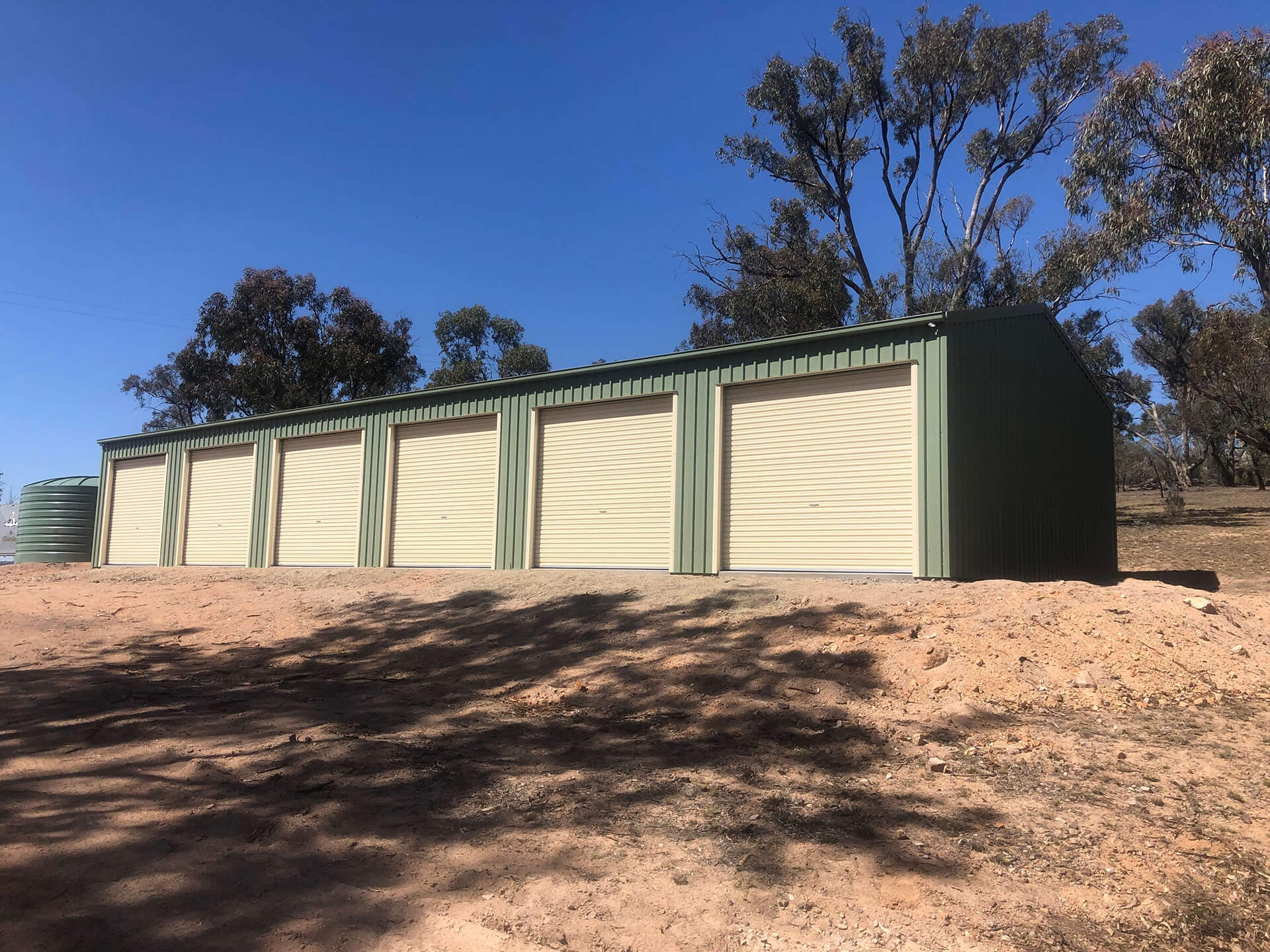 Industrial 6 door green shed with cream doors - Snowy Sheds