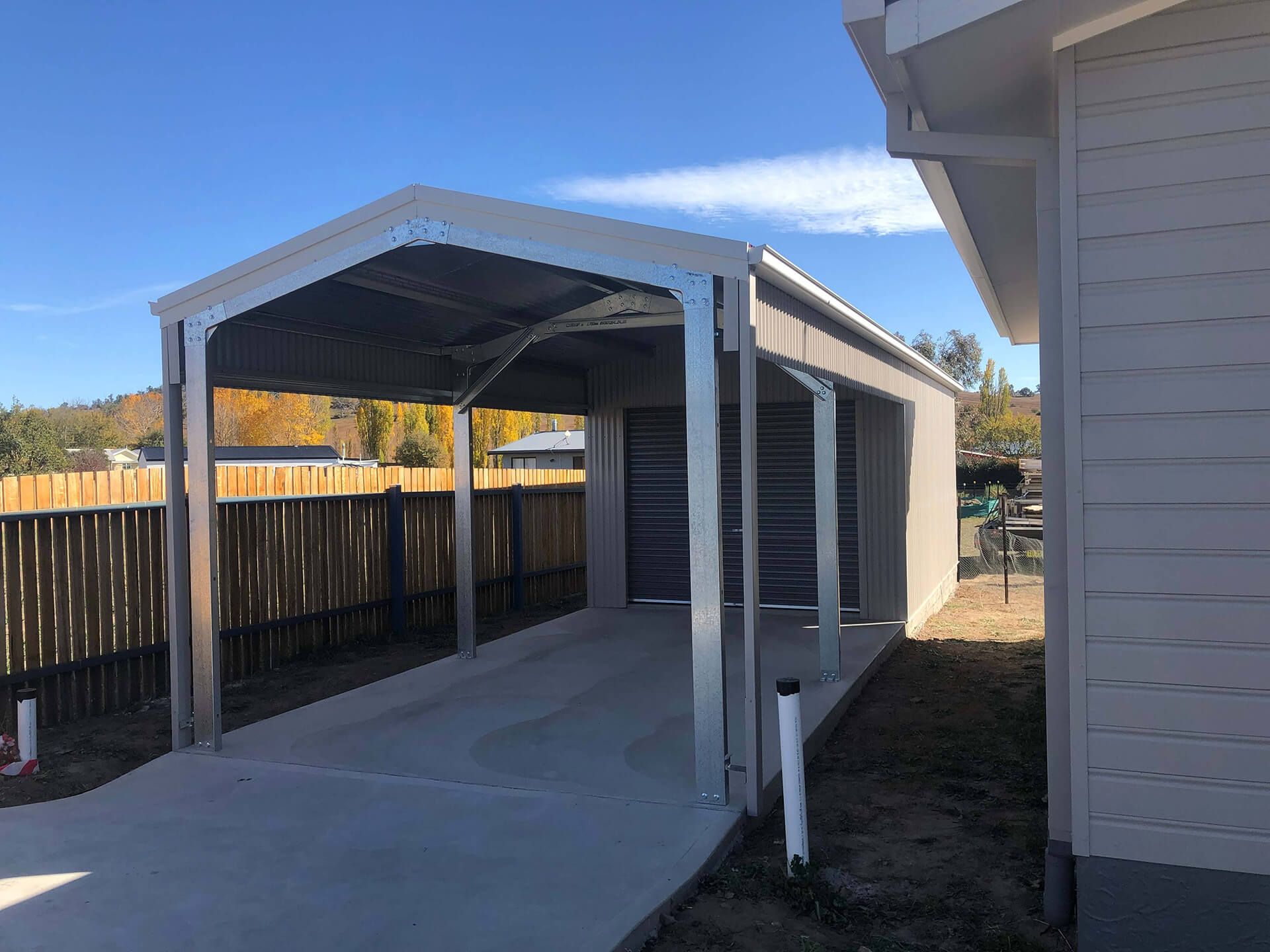 Flat roof Carport attached to house - Snowy Sheds