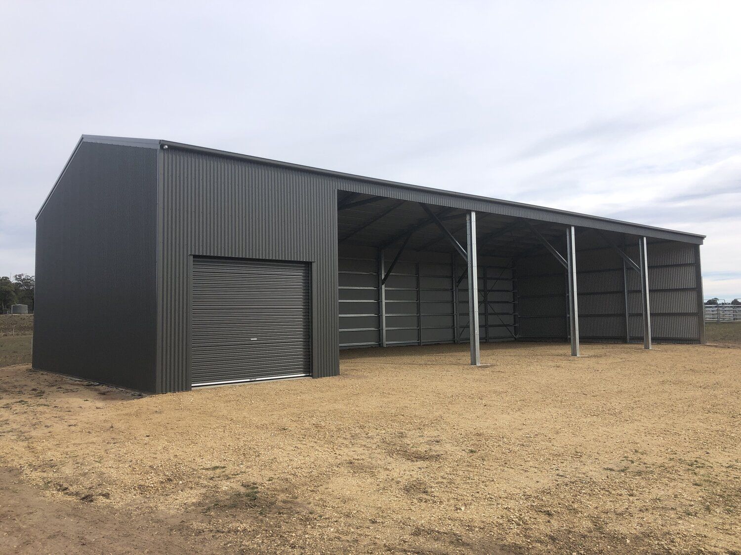 Large farm shed barn with open area and door entrance - Snowy Sheds