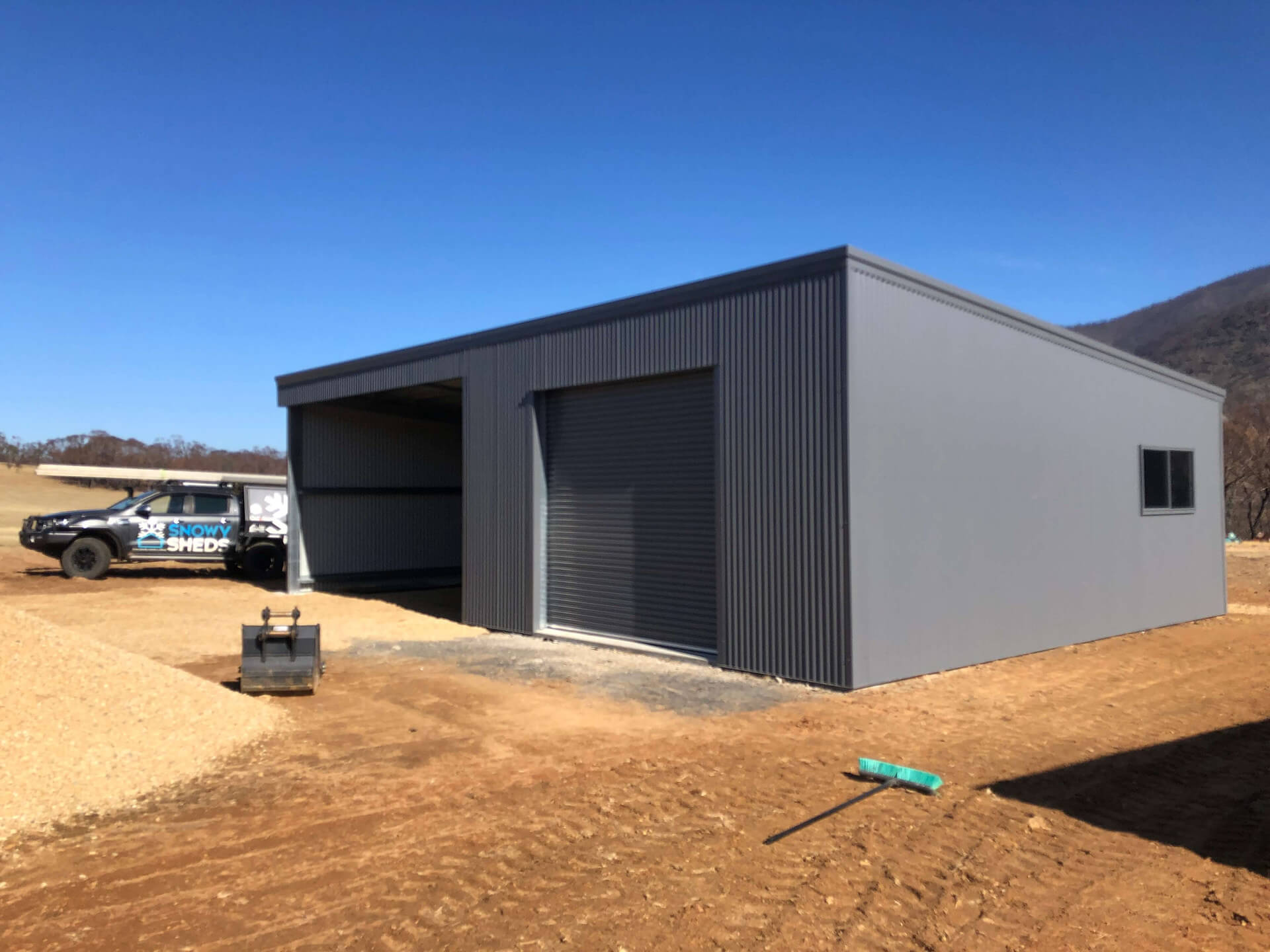 black shed front and side view - Snowy Sheds