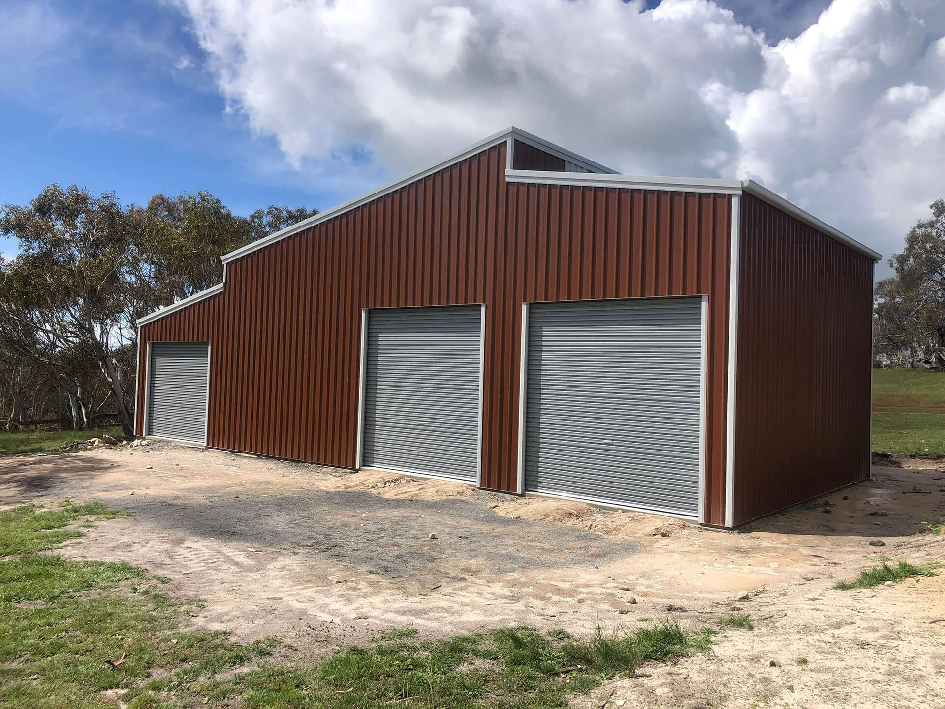 brick colored shed with grey doors - Snowy Sheds