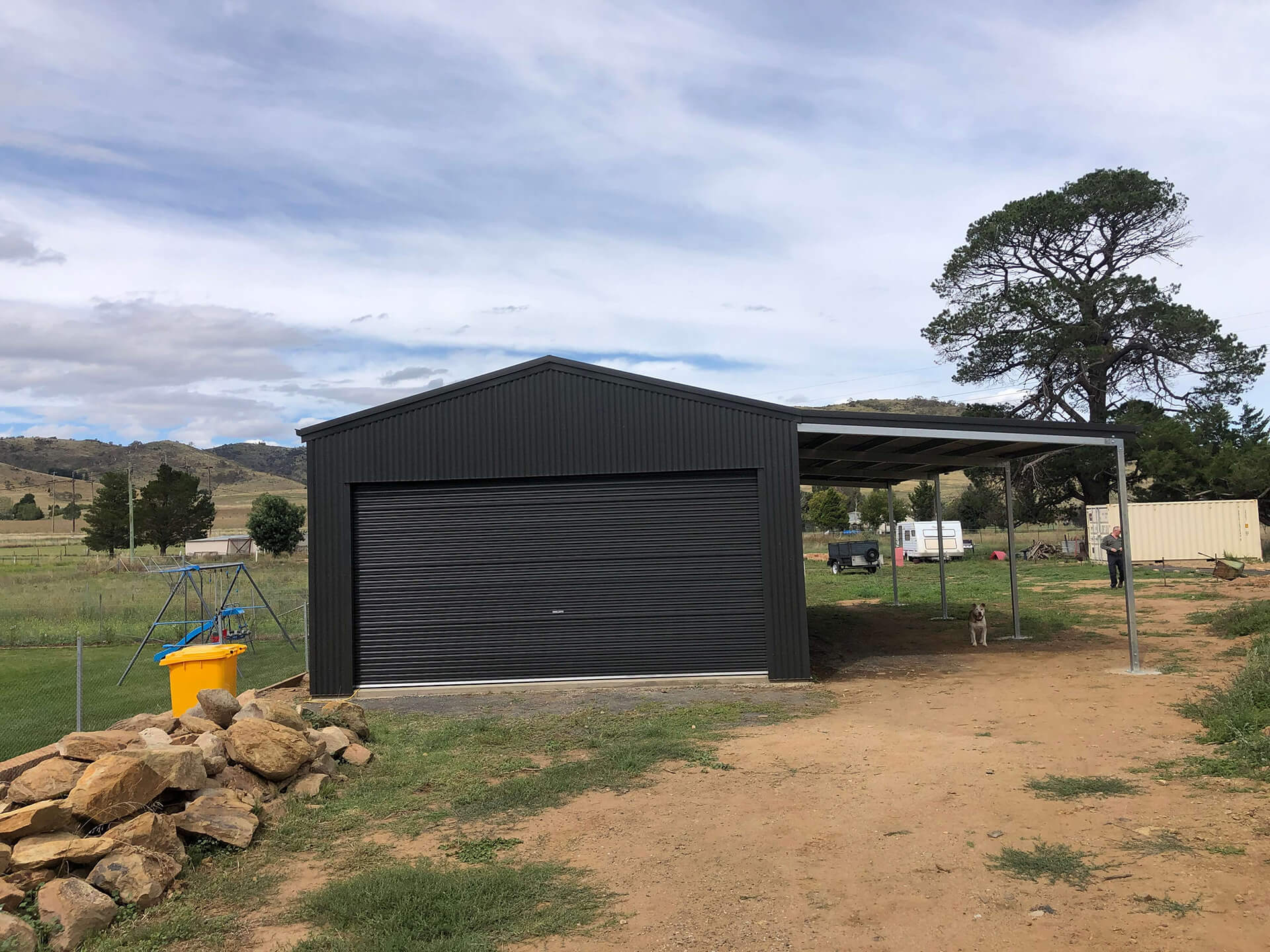 green shes with carport and grey door - Snowy Sheds
