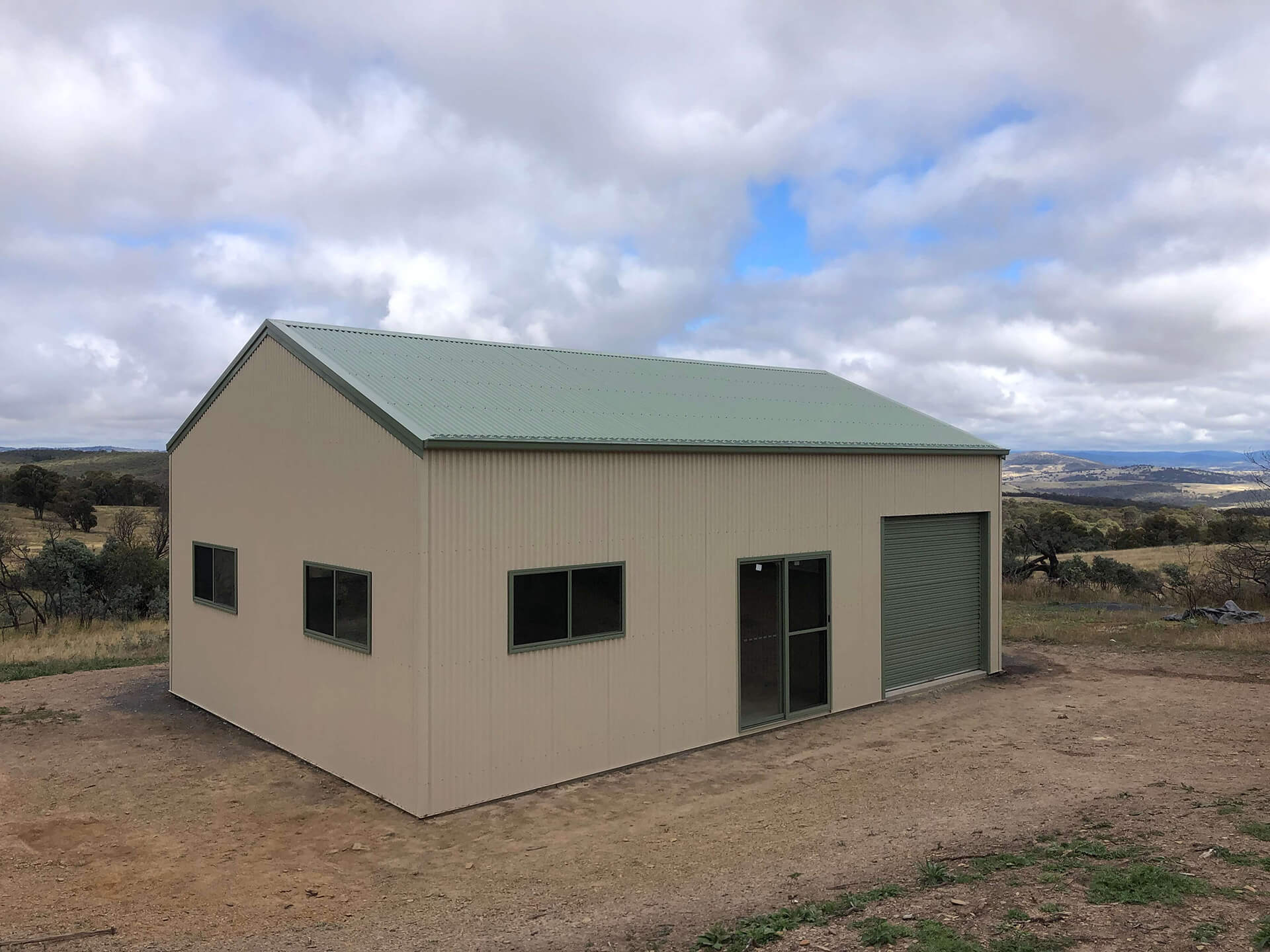 cream shed with green trim - Snowy Sheds