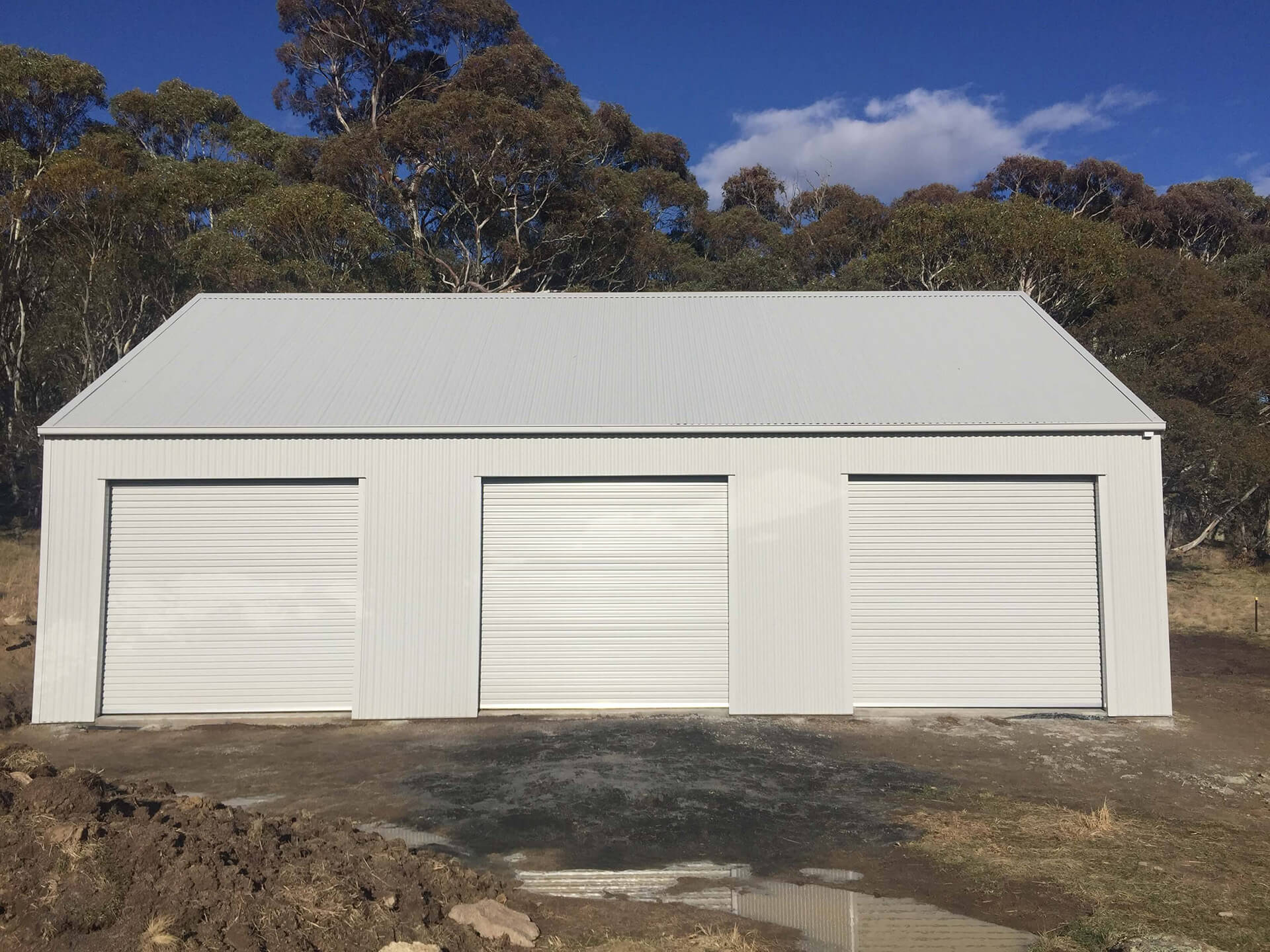 white small 3 door shed with white doors side view  - Snowy Sheds