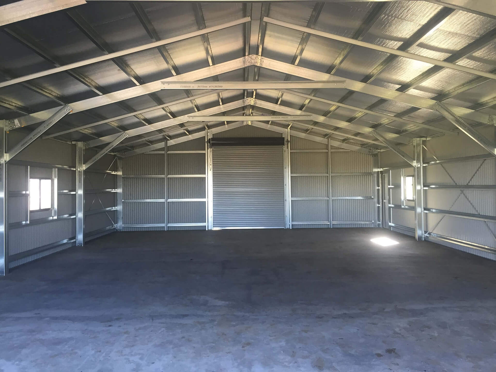 Industrial grey shed with grey doors interior - Snowy Sheds