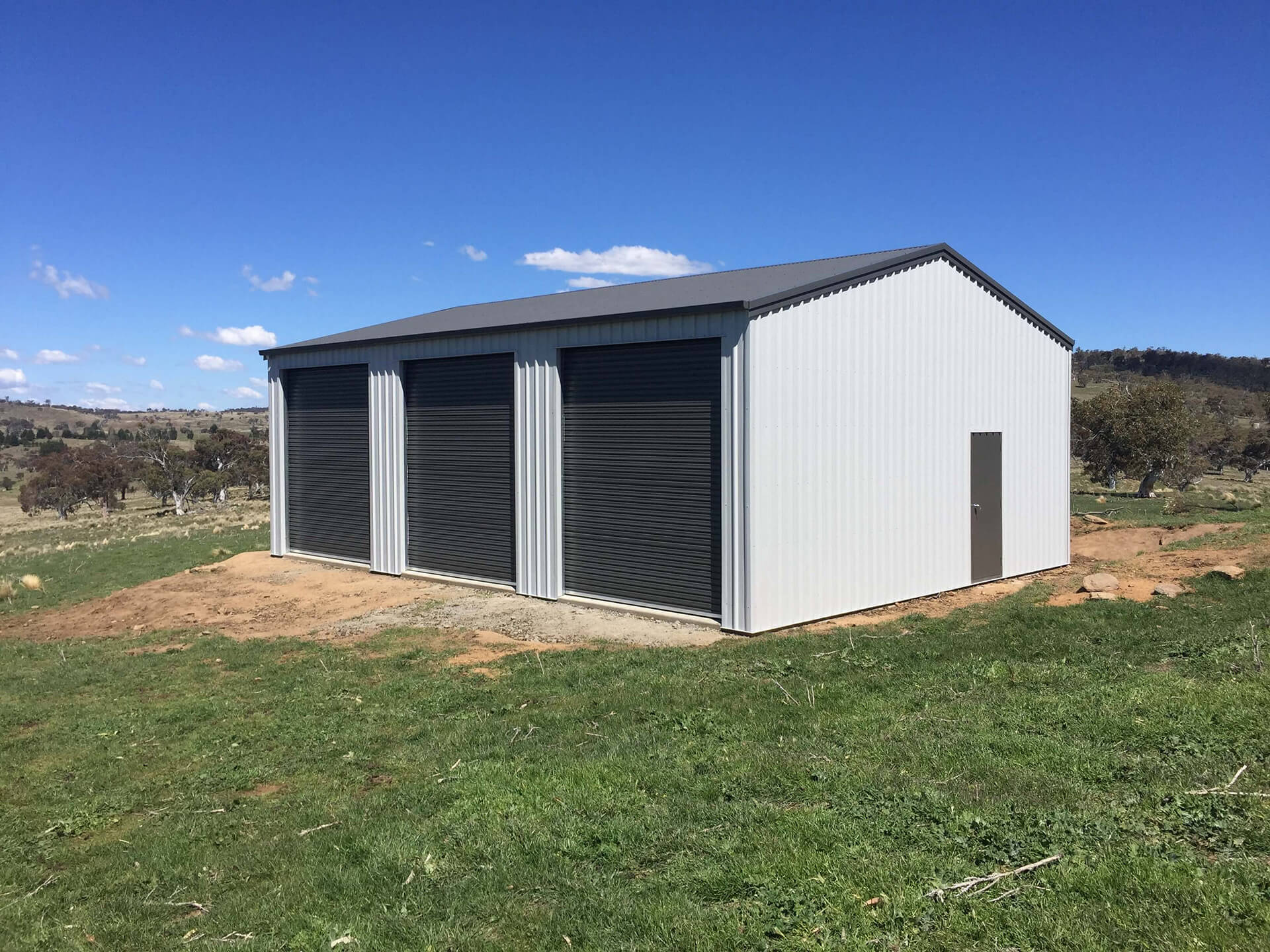 Industrial white shed with grey doors - Snowy Sheds