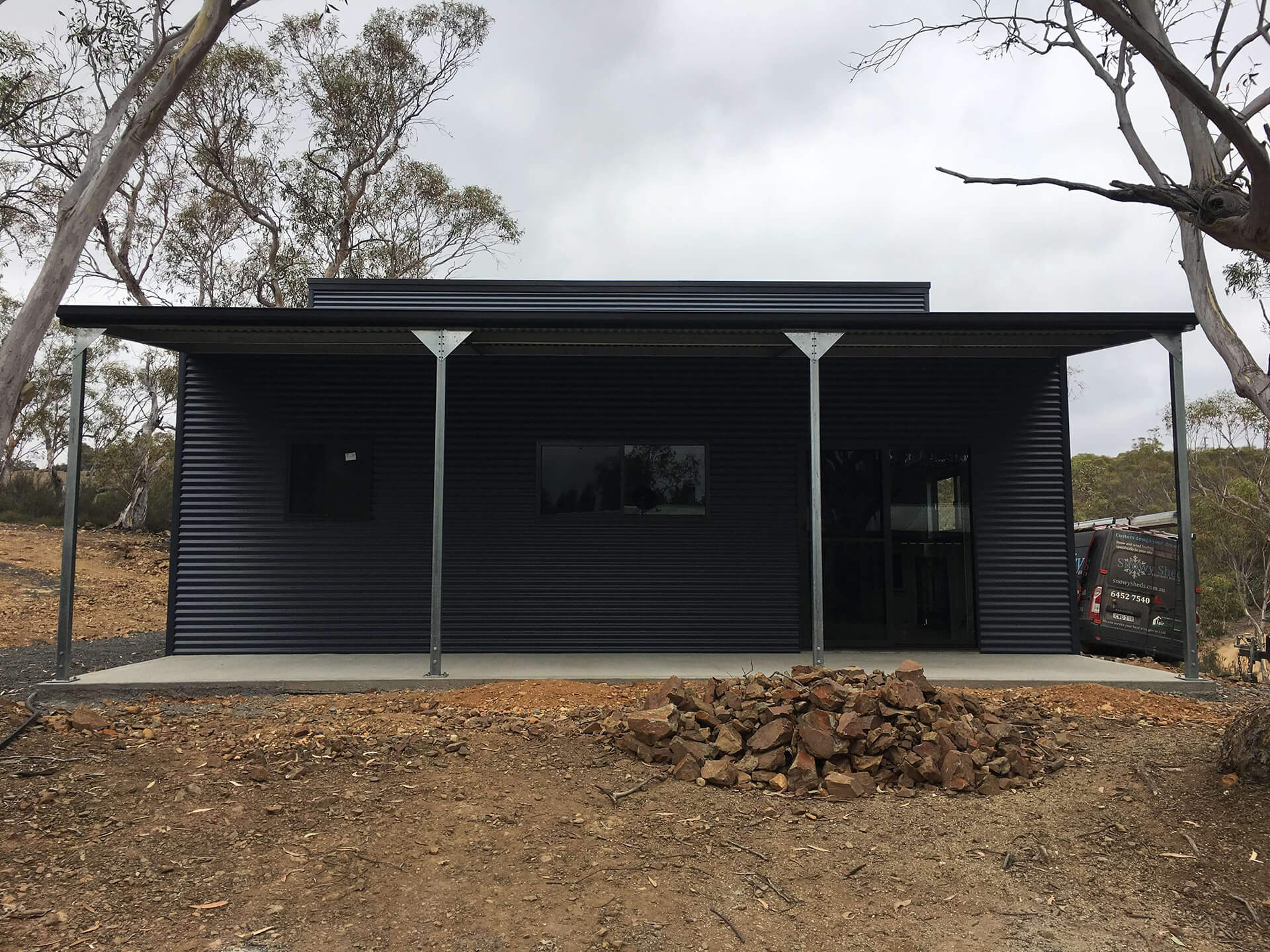 Black 3 door American style barn with carport