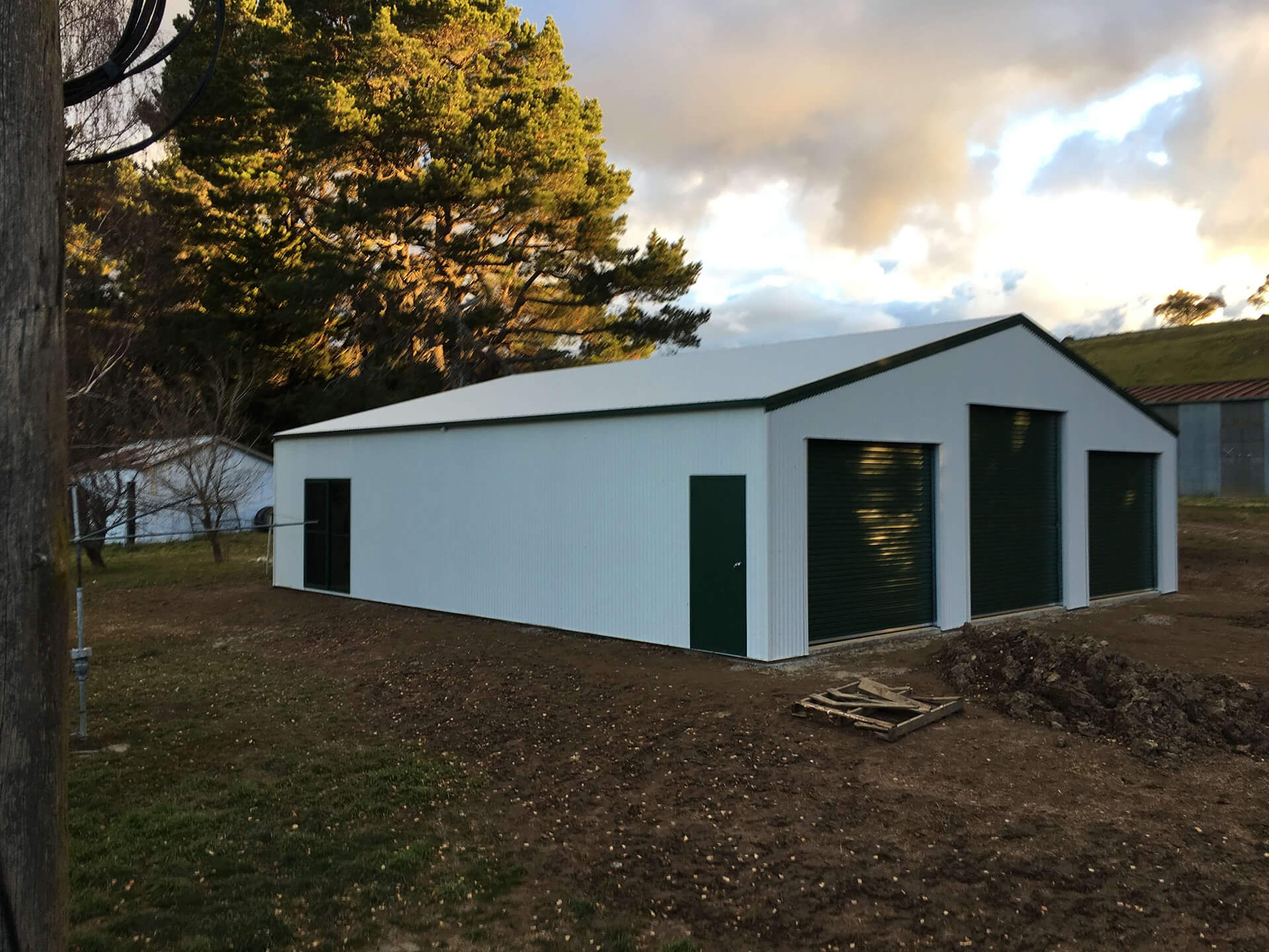white shed with green trims  - Snowy Sheds