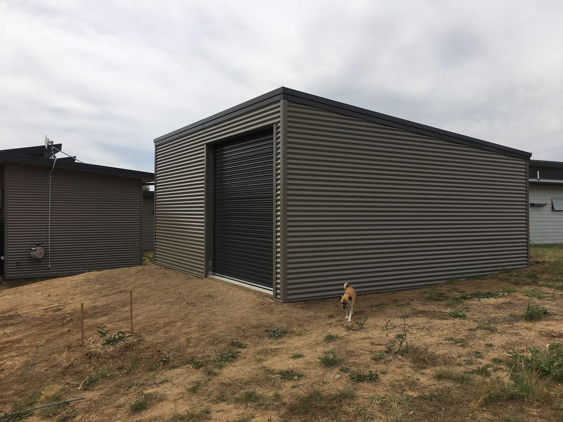 grey shed with black door  - Snowy Sheds