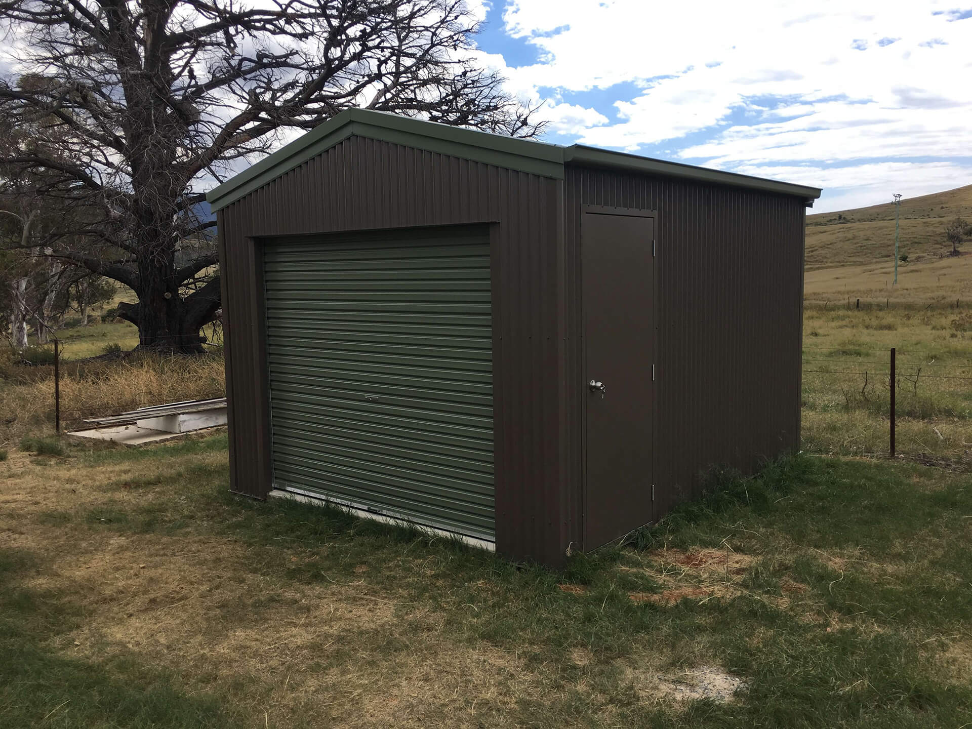 small 1 door black shed with green door  - Snowy Sheds