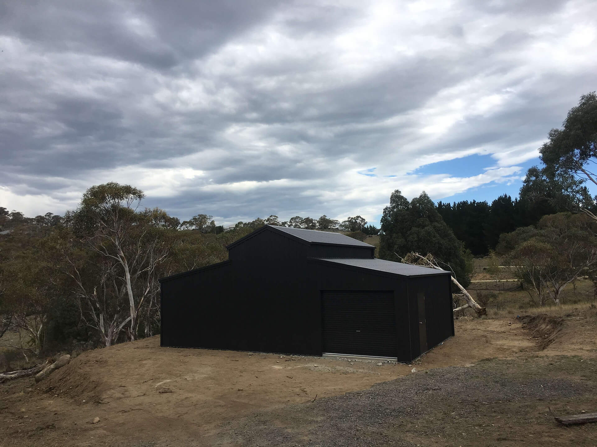 back of Black 3 door American style barn shed