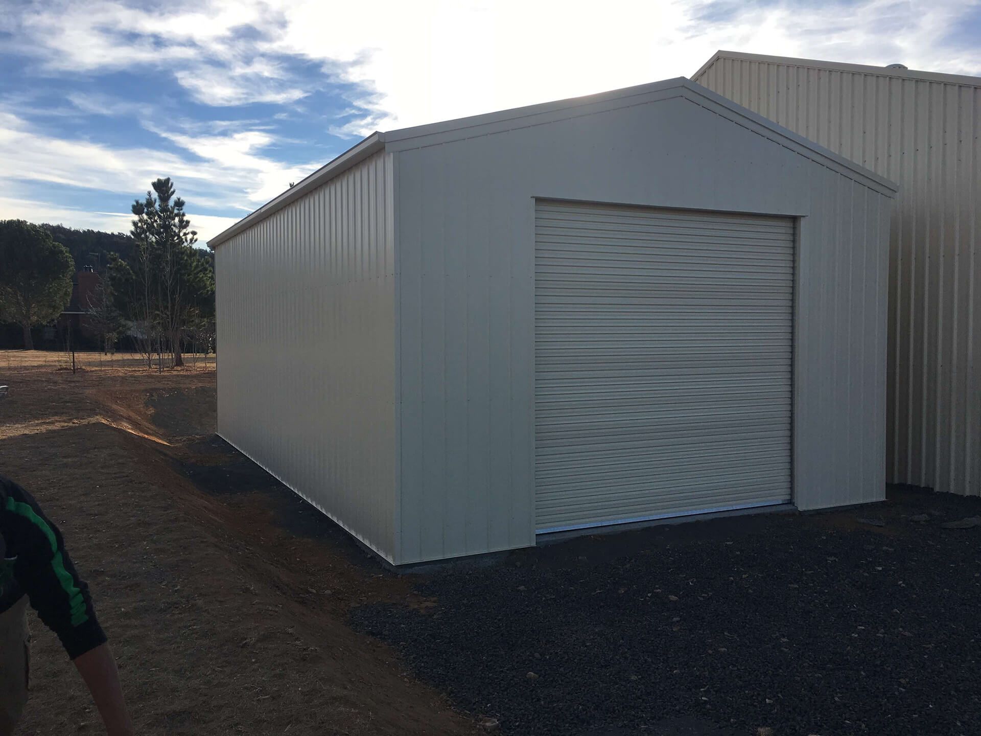 white shed with 1 white door  - Snowy Sheds