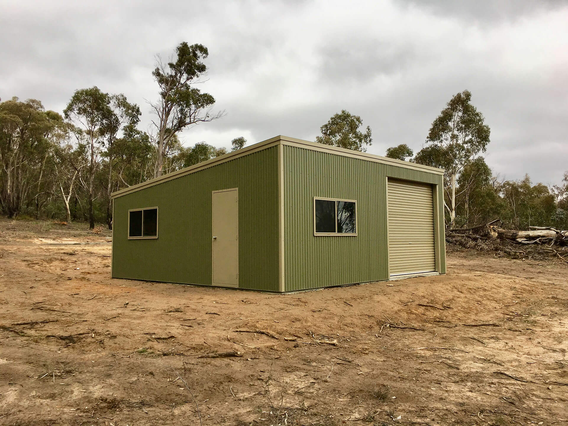 green shed with 2 cream doors  - Snowy Sheds