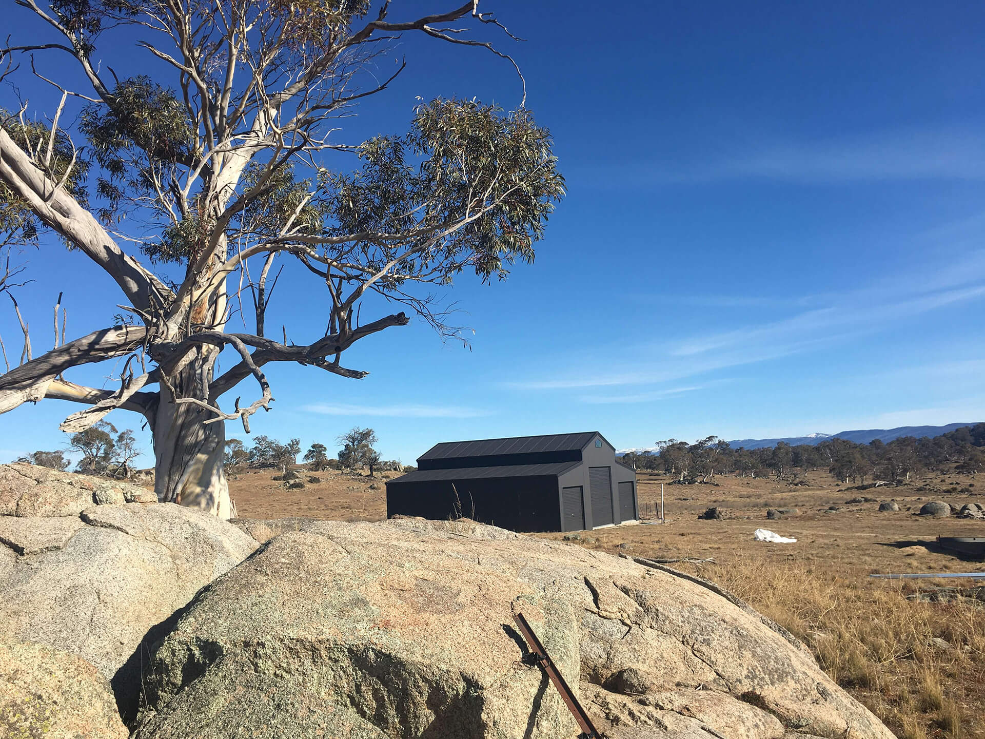 Black 3 door American style barn shed from far away