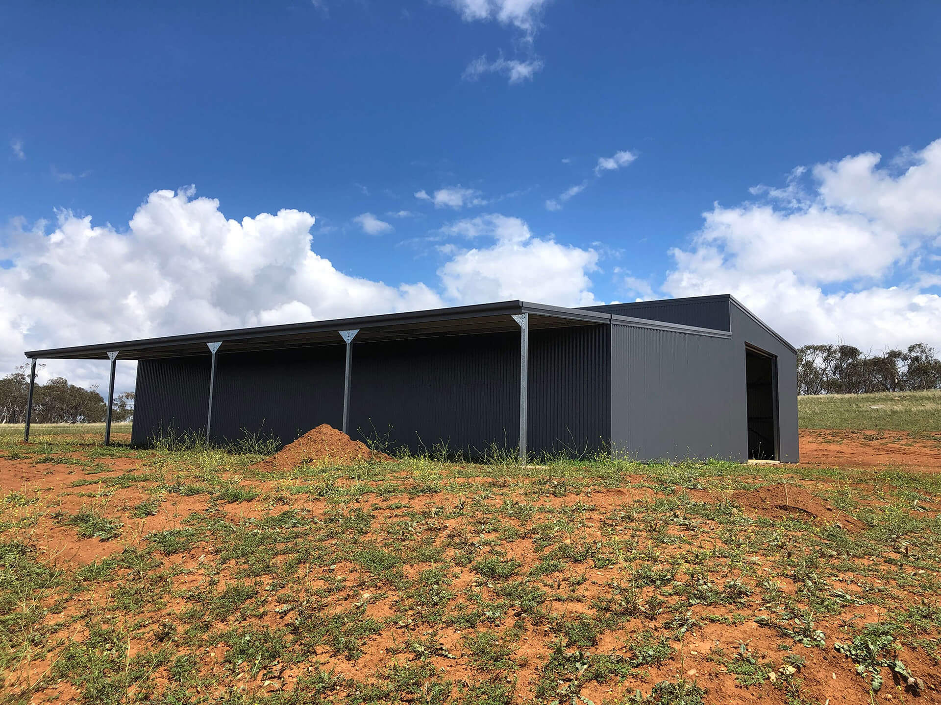 black shed side view with carport - Snowy Sheds