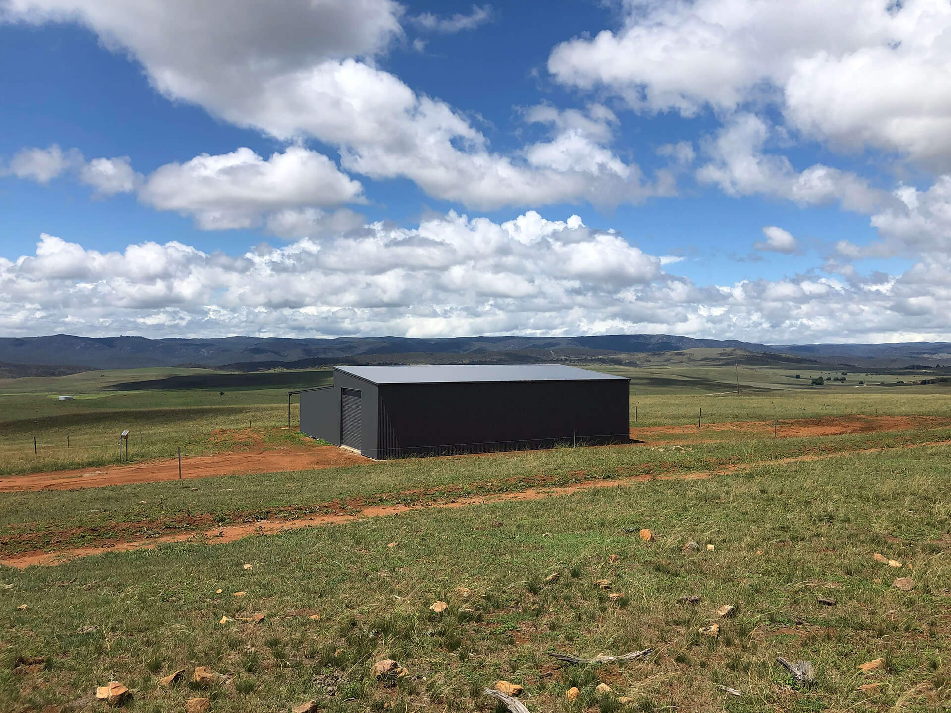 black shed side view far away  - Snowy Sheds