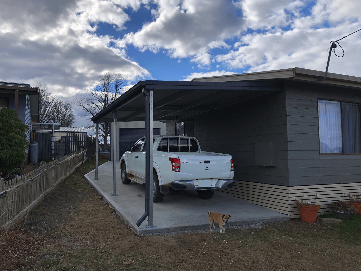 Carport covering white truck - Snowy Sheds