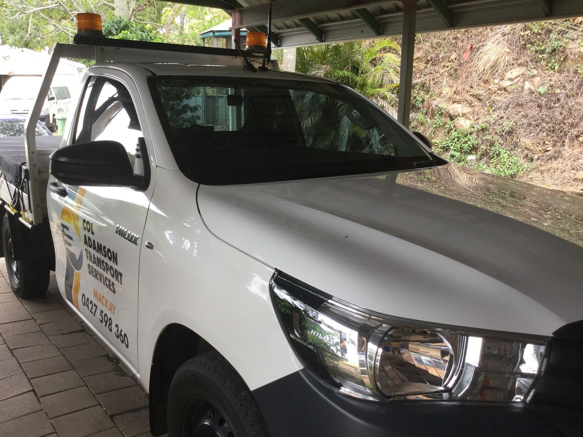 White Toyota Hilux Truck with Orange Lights — Col Adamson Transport Services in Townsville, QLD