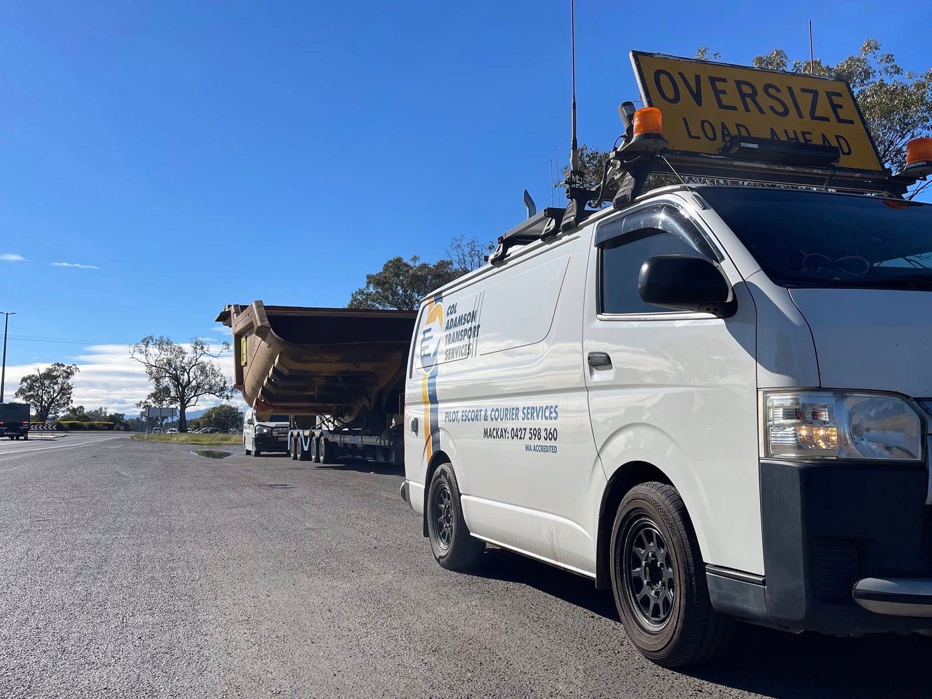 A white pilot vehicle with an 