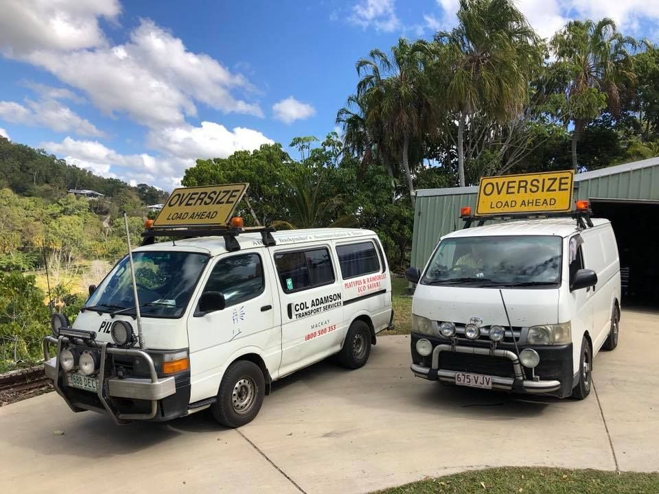 Two White Vans Under a Blue Sky — Col Adamson Transport Services in Emerald, QLD