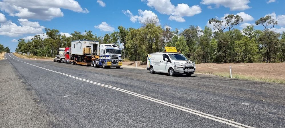 Large Trucks and White Van on a Long Highway — Col Adamson Transport Services in Dysart, QLD