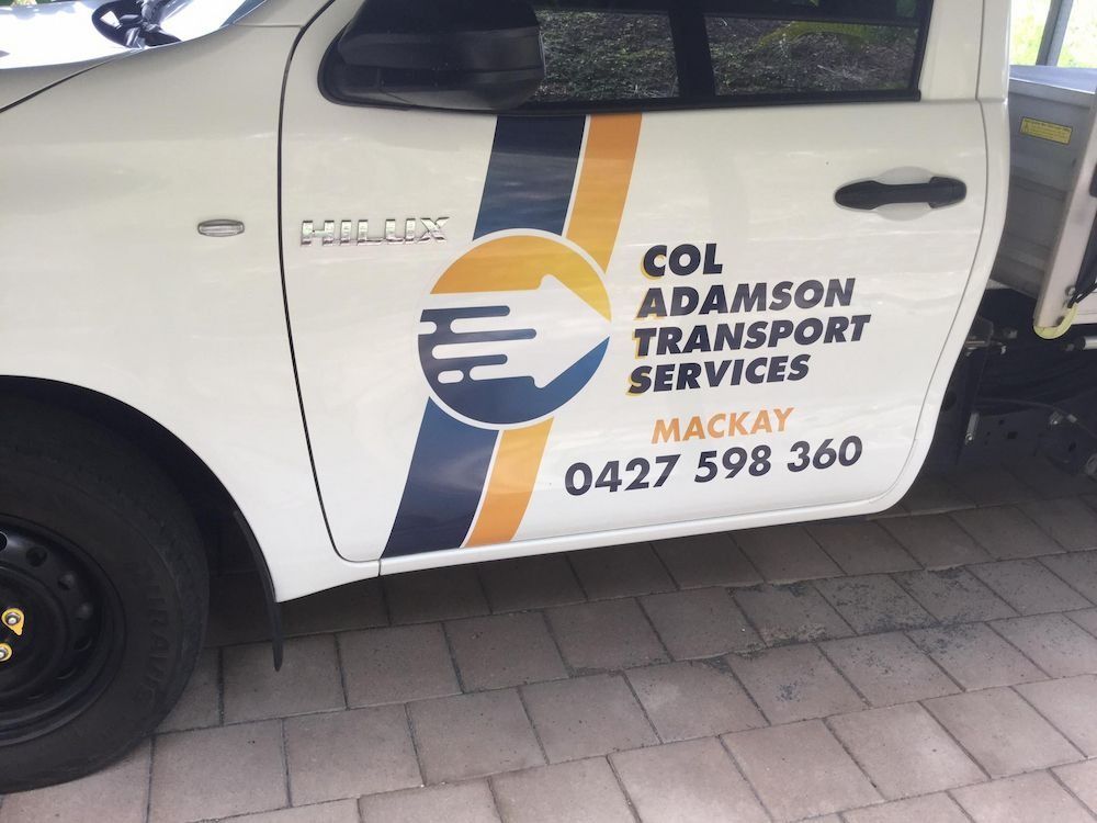 White Truck Door With Col Adamson Transport Services Logo and Phone Number — Col Adamson Transport Services in Moranbah, QLD