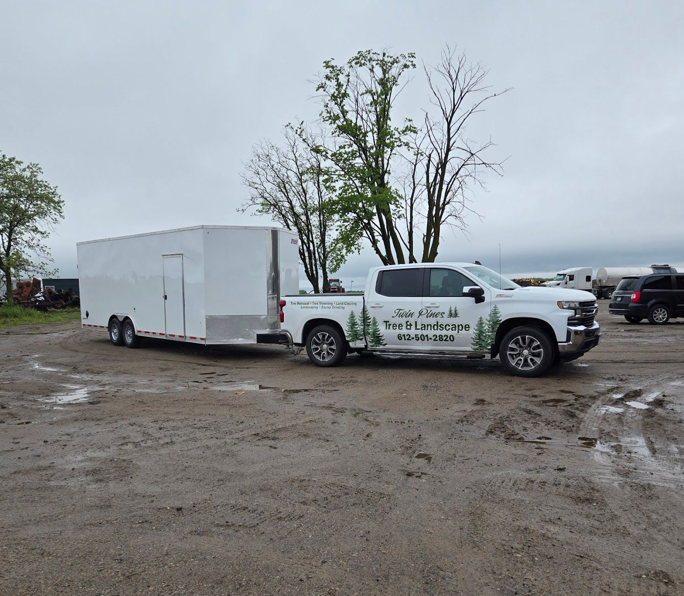 A hand holds a scoop of dark, rich soil over a garden bed in warm, natural sunlight.