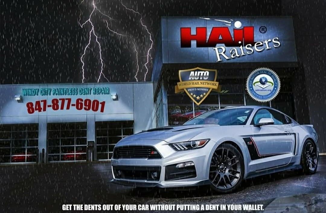 White sports car parked outside Hail Raisers auto repair shop with lightning and service signs.