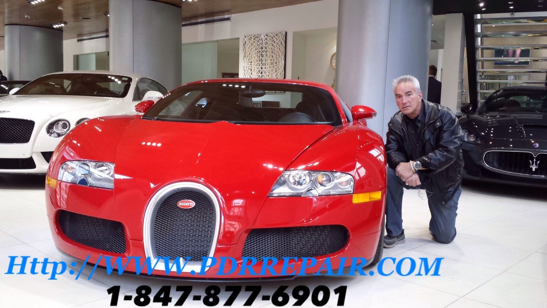 Man posing beside a red sports car in a showroom, with dealership text and phone number overlaid