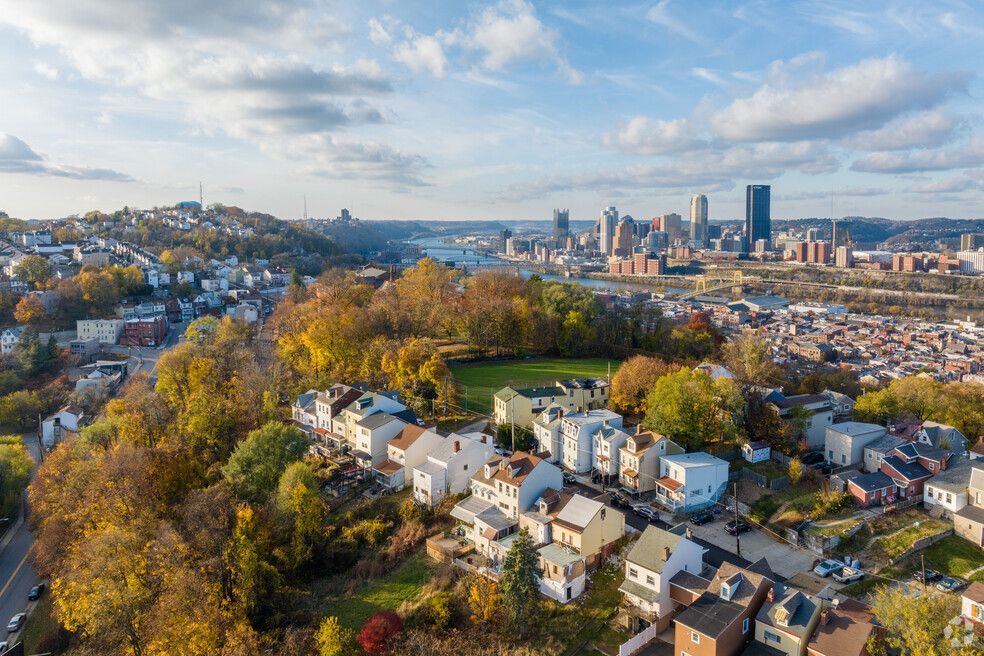 An aerial view of a residential area with a city in the background.