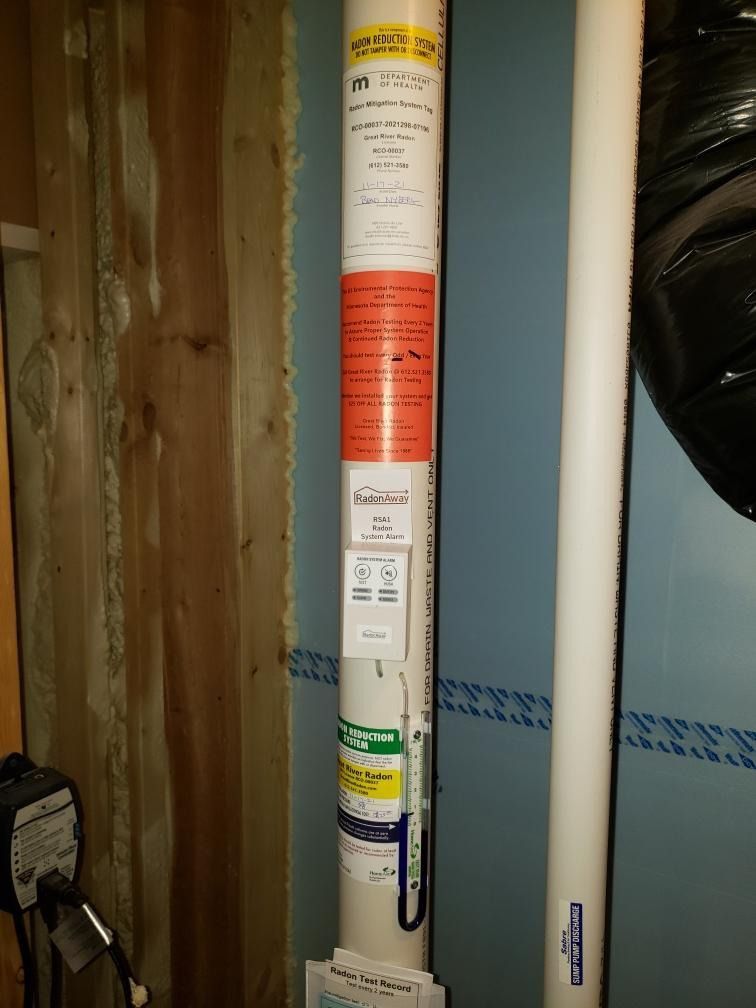 A white pipe with a lot of stickers on it