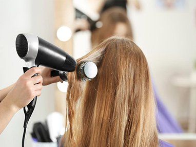 Stylist Blow-Drying Hair — Hair Salon in Sippy Downs, QLD