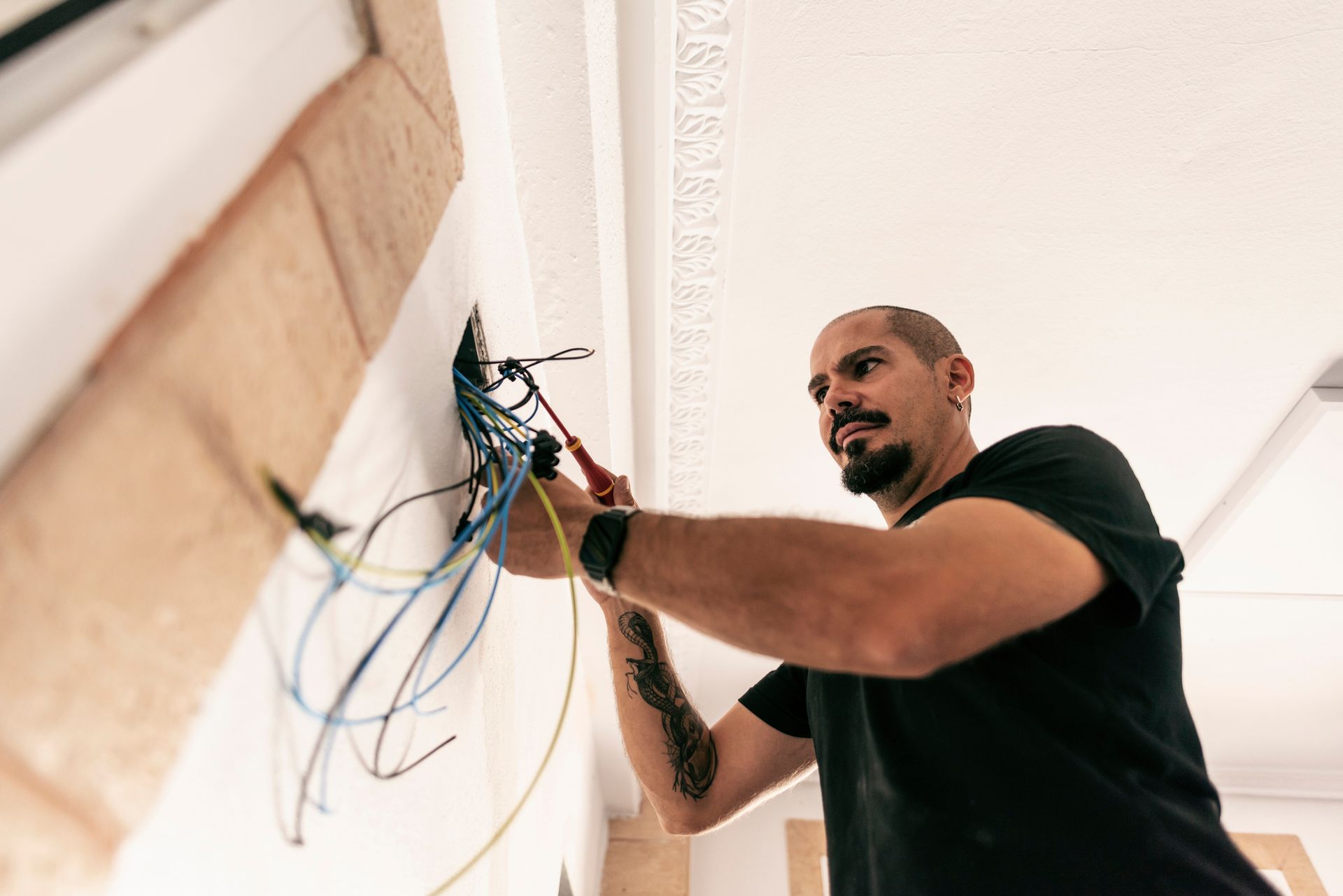 Electrician prepares the installation of electrical wiring in the renovation of a home.