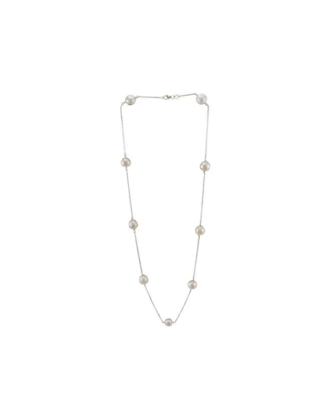 A long silver chain necklace featuring nine evenly spaced white pearls against a plain white background.