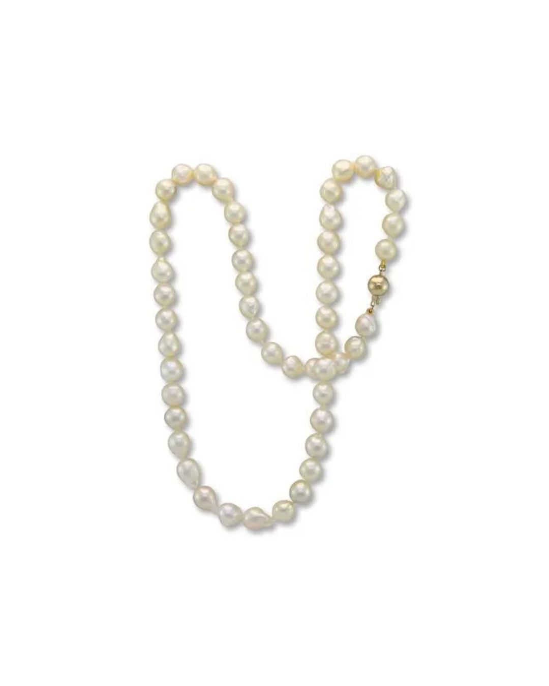 A long string of lustrous, off-round cream-colored pearls with a polished gold clasp.